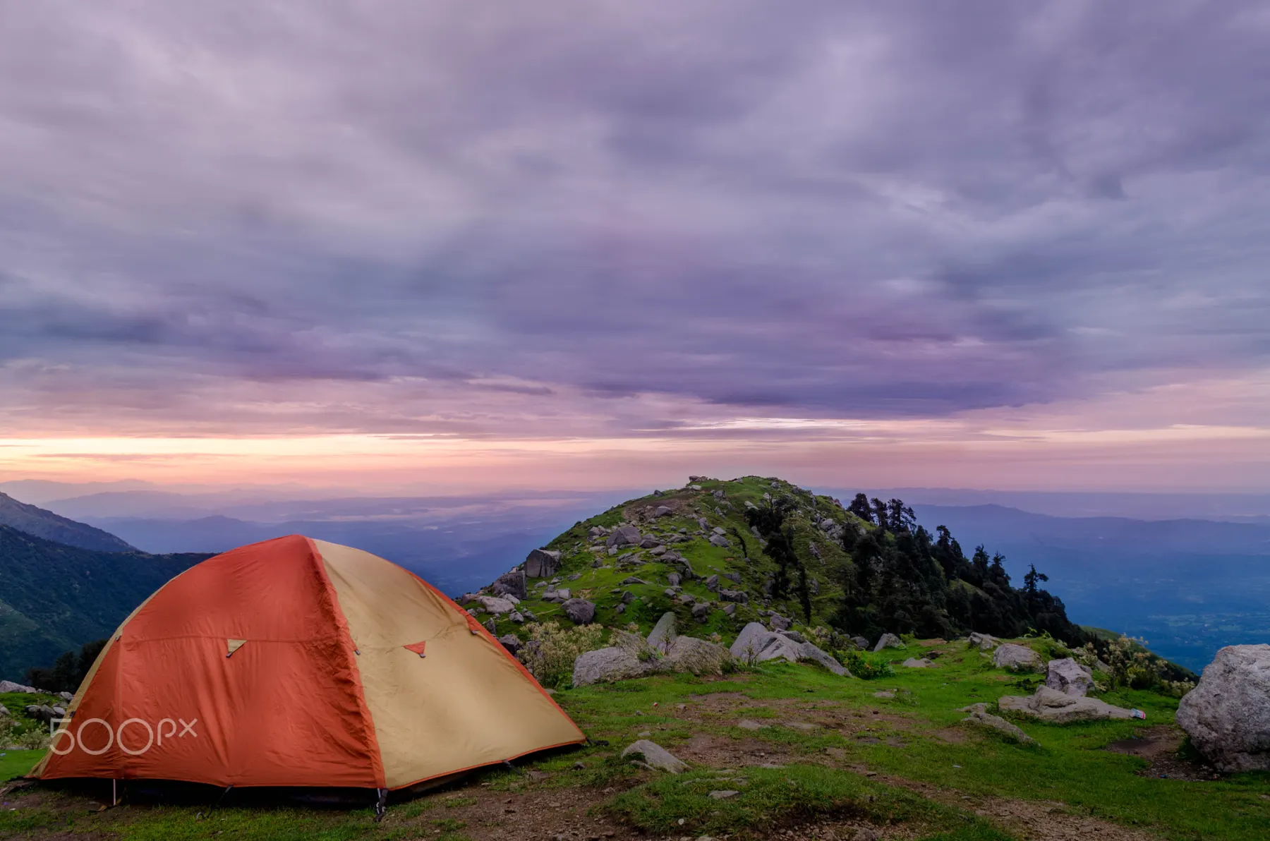 A tent pitched on the ridge as the light goes