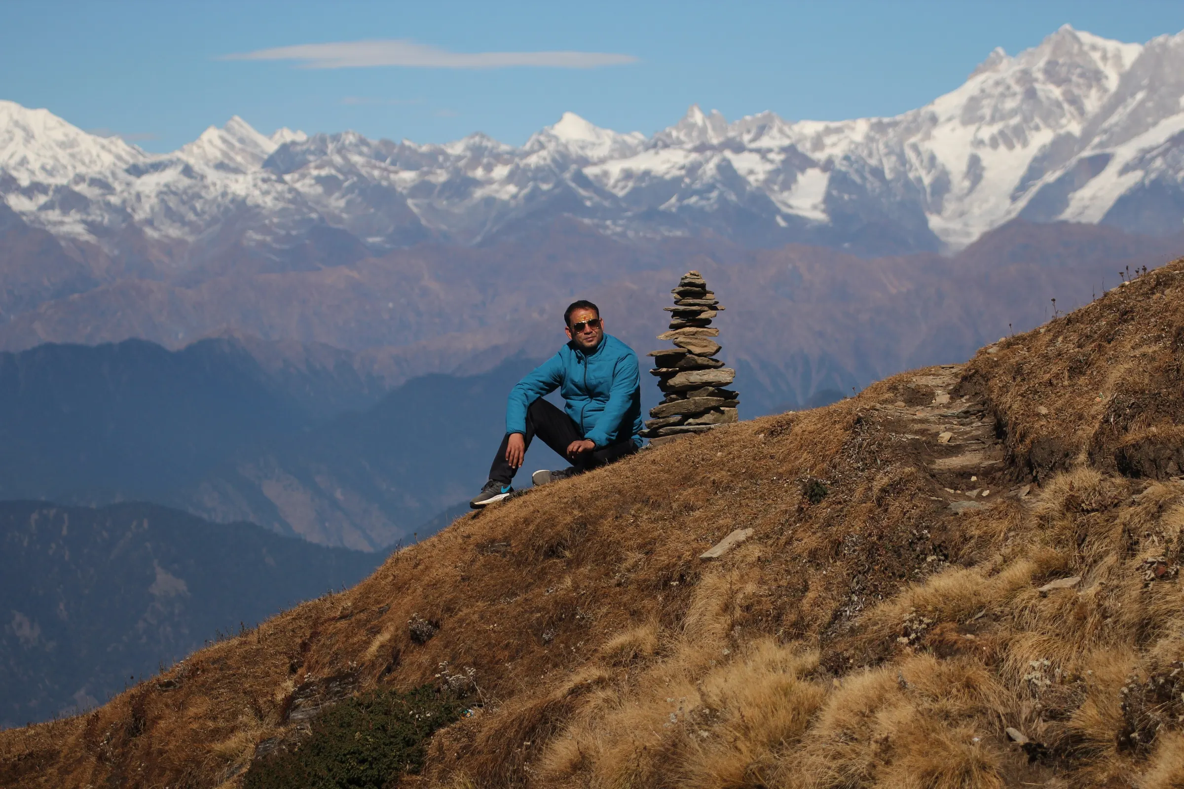 Trekkers on the Chandrashila ridge above Tungnath temple at sunrise