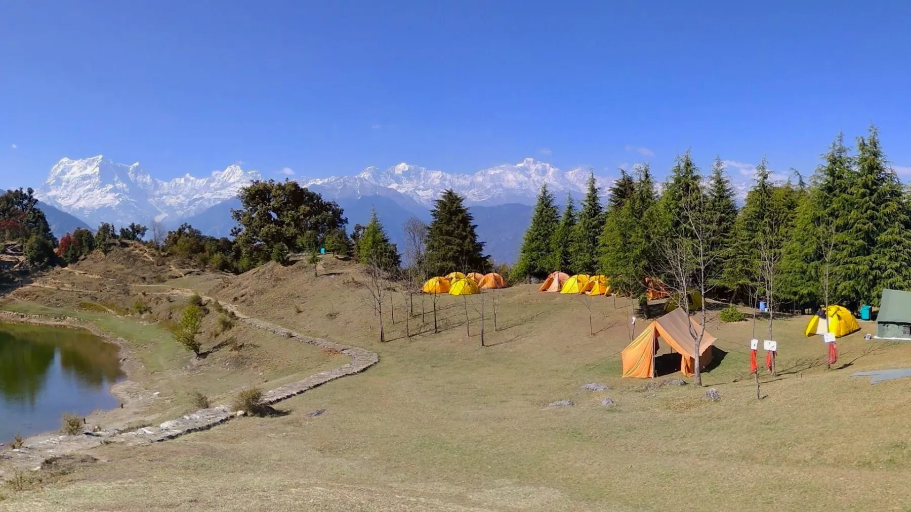 Trekkers on a meadow trail above Joshimath