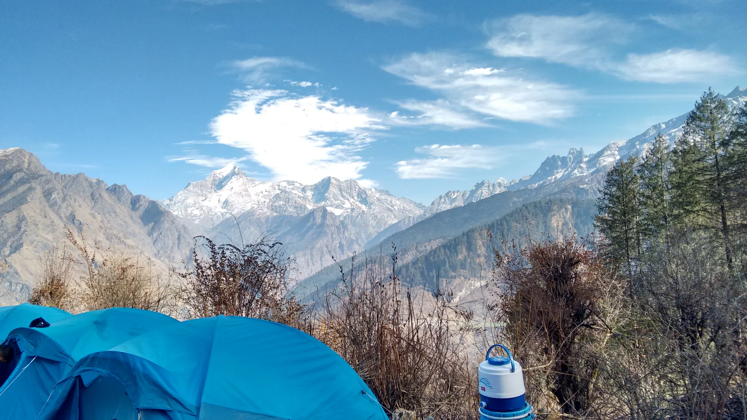 Trekkers on the meadow ridge near Kuari Pass with Nanda Devi behind